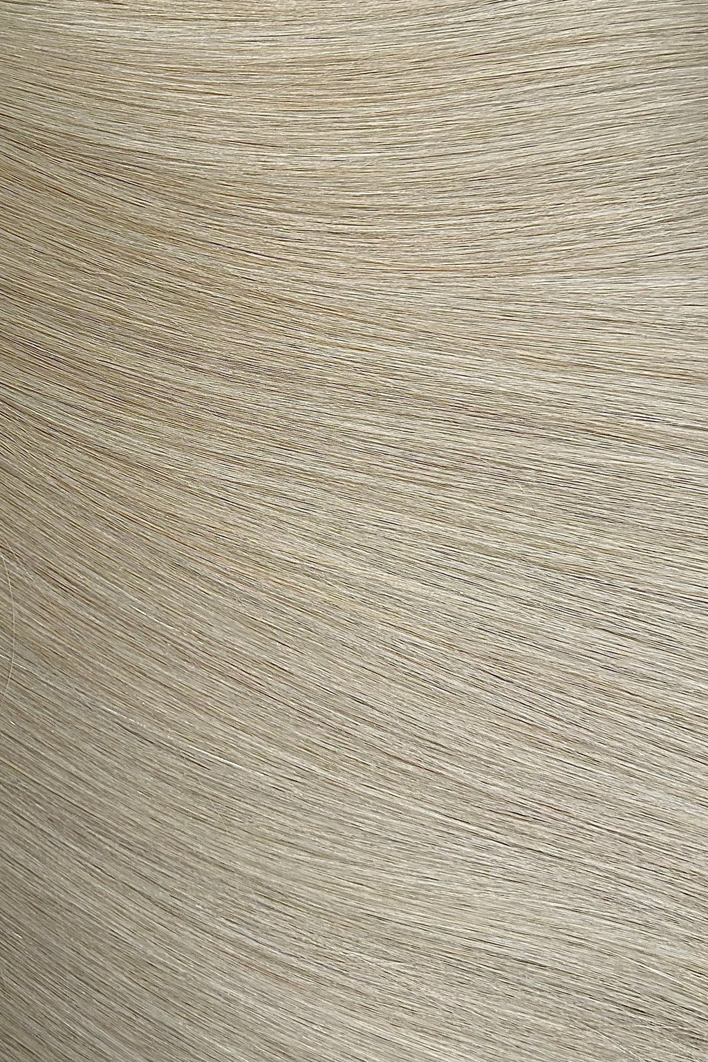 Close-up of a textured beige hair extensions surface with horizontal lines