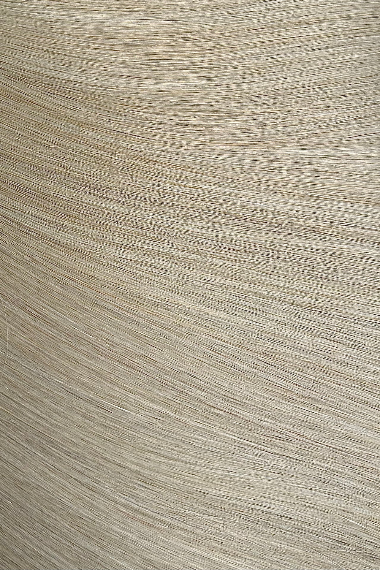 Close-up of a textured beige hair extensions surface with horizontal lines